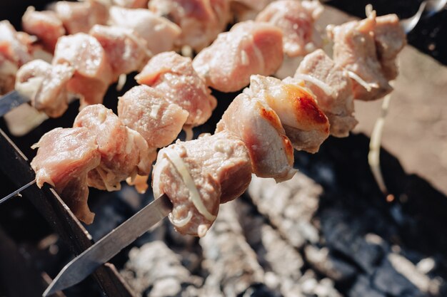 Barbecue on the grill in nature. cooking on fire. fried meat and food.