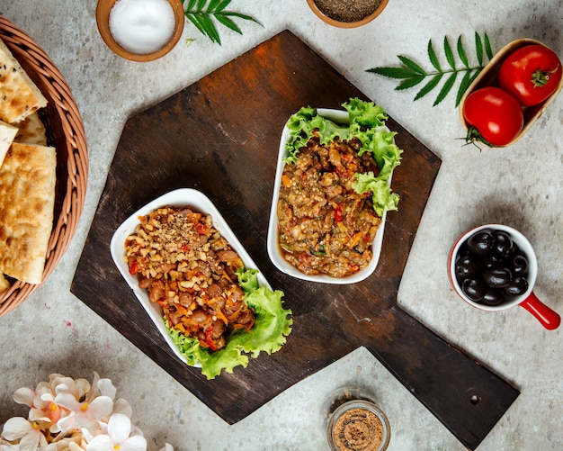 Barbecue salad and salad with beans on a wooden board