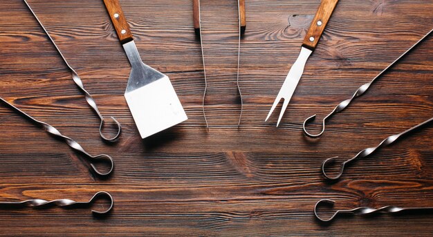 Barbecue utensil set on wooden table