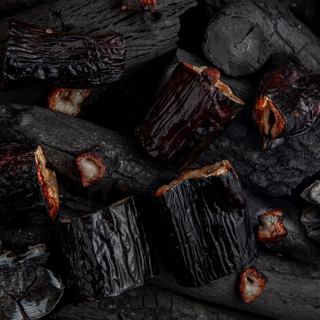 Barbecued egg-plants on charcoal.