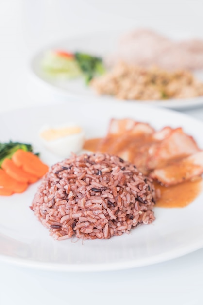 Barbecued red pork in sauce with berry rice