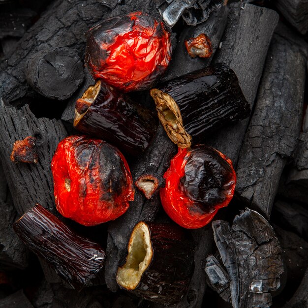 Barbecued vegetables from tomatoes and egg-plants on charcoal, flat lay.