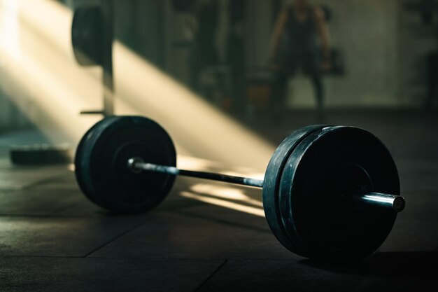 Barbell on the floor in empty health club