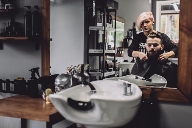 Barber and customer in mirror