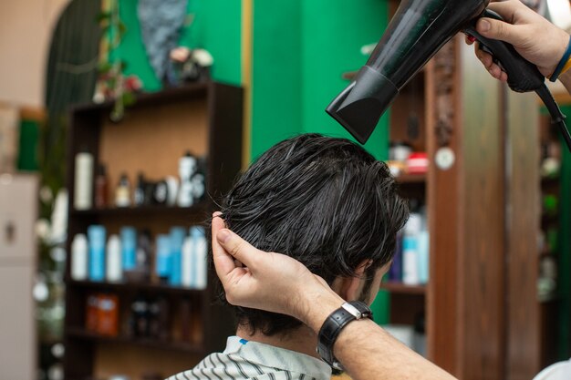 A barber dries hairs