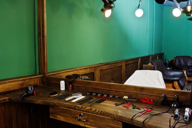 Barber equipment on the working surface by the mirror in the barbershop