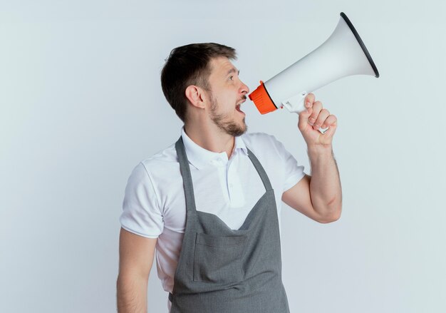 barber man in apron shouting to megaphone standing over white wall