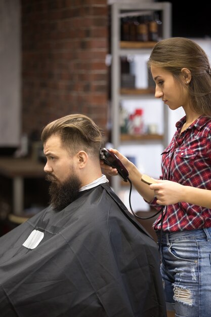 Barber woman making haircut