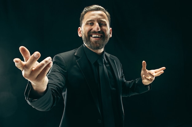 The barded man in a suit. Stylish business man on black studio