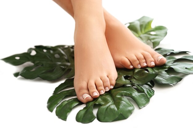 Bare feet on leaves. Foot care and pedicure concept