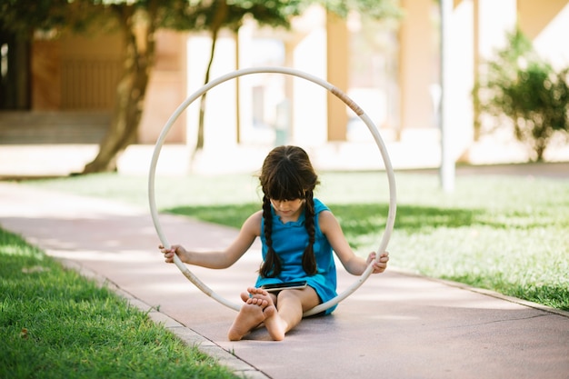 Barefoot girl with hula hoop