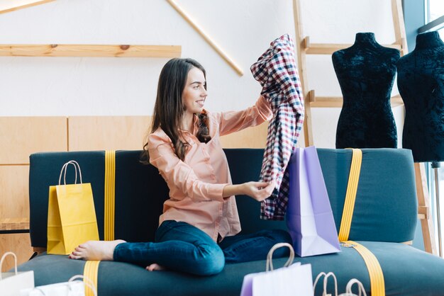 Barefoot woman looking at purchases