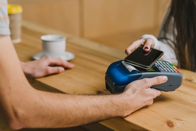 Barista accepting payment with smartphone