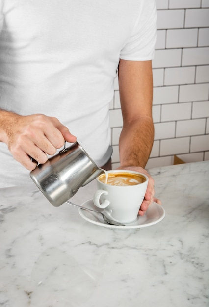 Barista making latte art in cappuccino