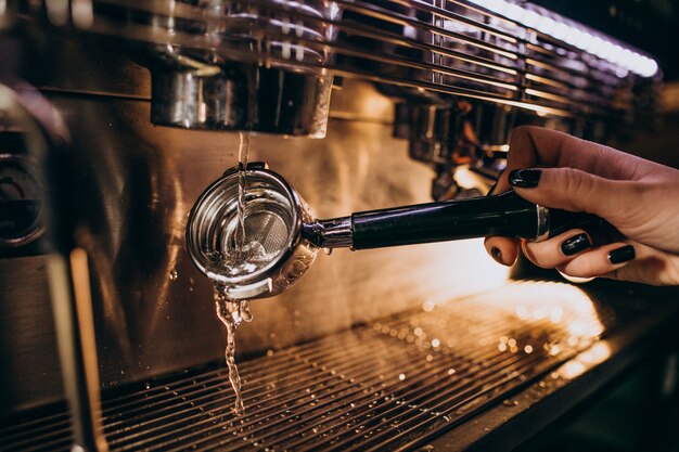 Barista preparing coffee in a coffee machine