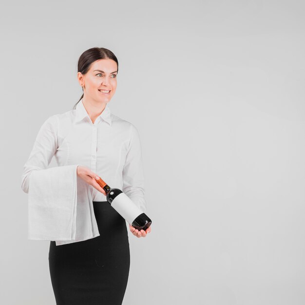 Barkeeper holding bottle of wine