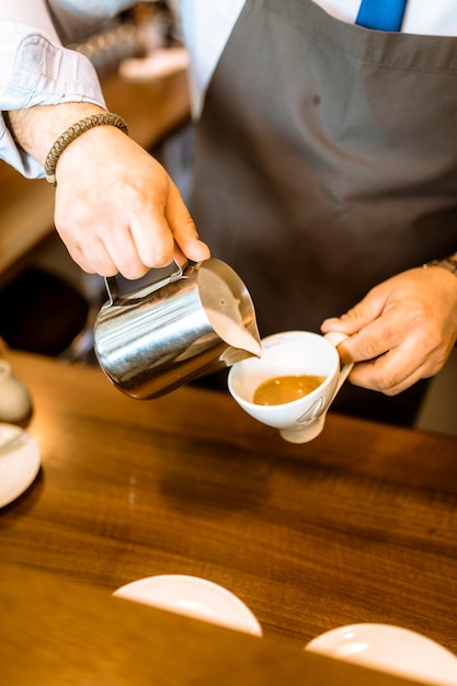 Free photo barman making milk coffee