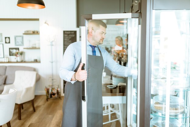 Barman opening fridge