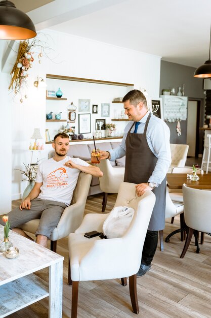 Barman serving cocktail