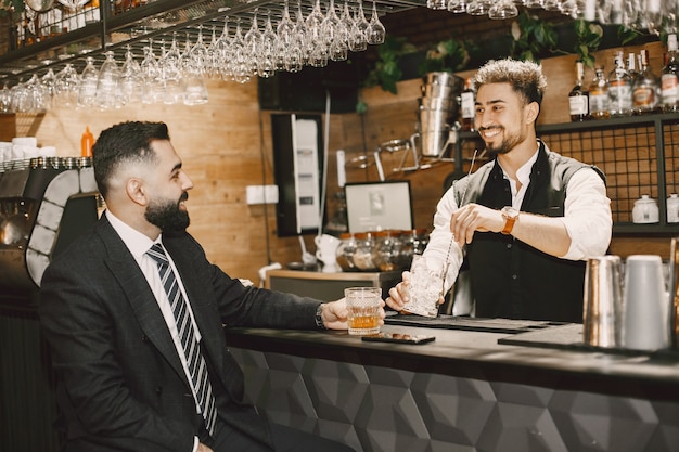 Bartender and businessman in a bar