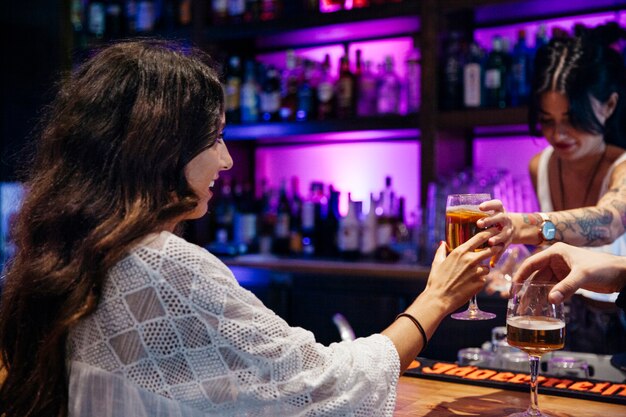 Free photo bartender giving drink to woman