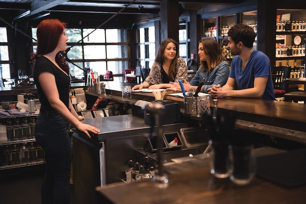 Free photo bartender interacting with customers