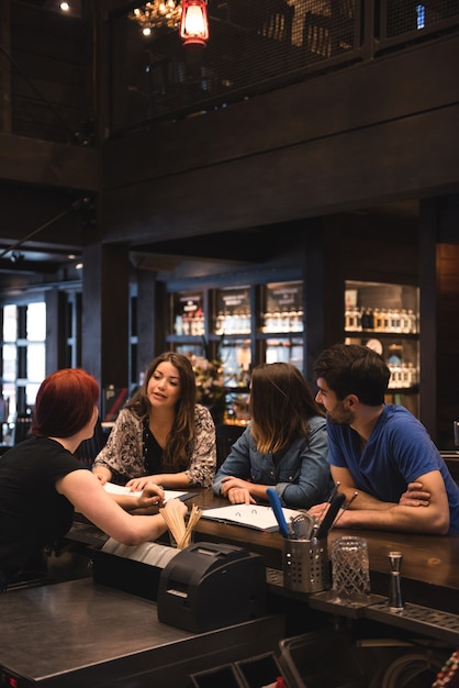 Free photo bartender interacting with customers