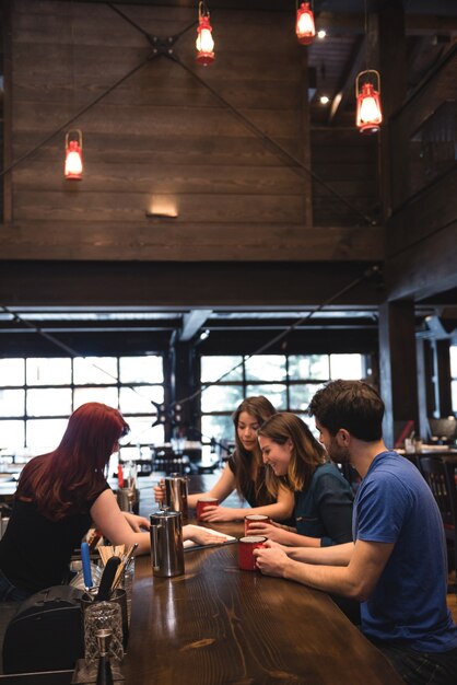 Bartender interacting with customers