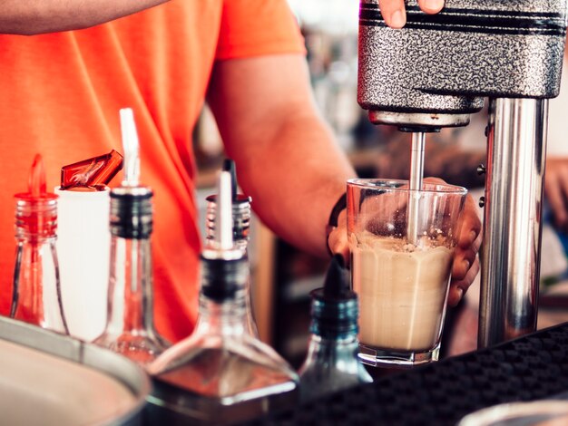 Bartender mixing tasty drink 