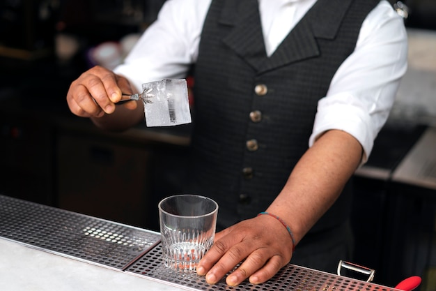 Bartender preparing drink at bar