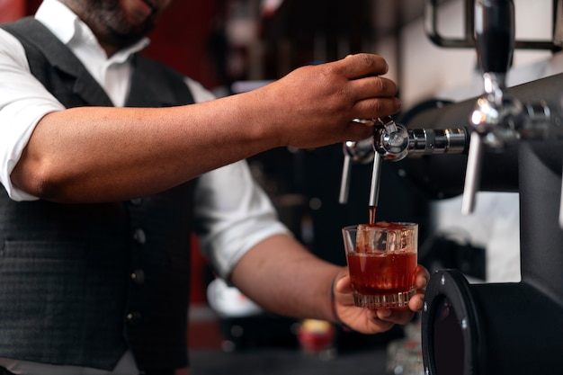 Bartender preparing drink at bar