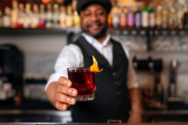 Bartender preparing drink at bar