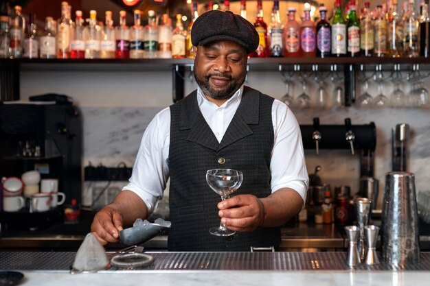 Bartender preparing drink at bar