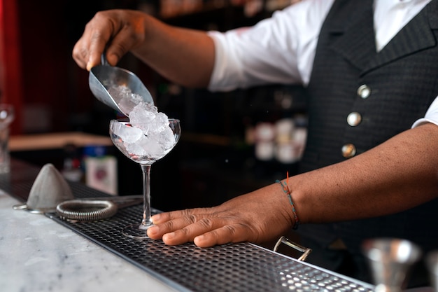 Foto gratuita barista che prepara drink al bar