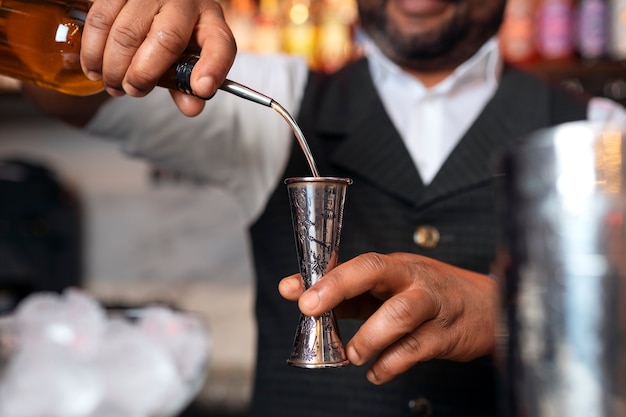 Foto gratuita barista che prepara drink al bar