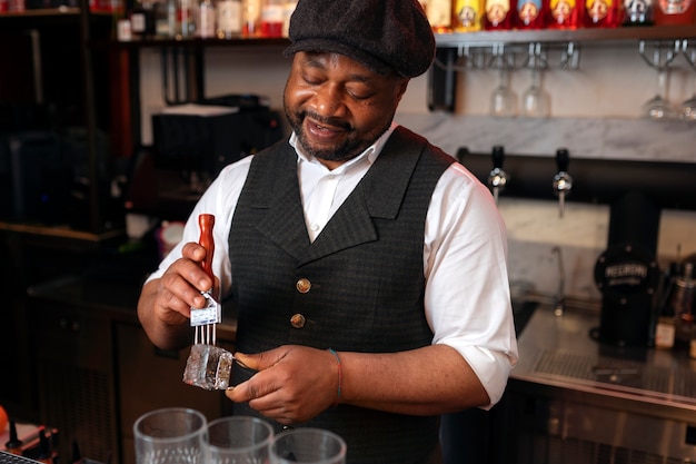 Foto gratuita barista che prepara drink al bar