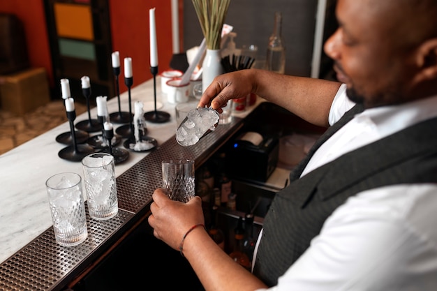 Bartender preparing drink at bar