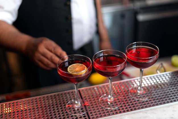 Free photo bartender preparing drink at bar