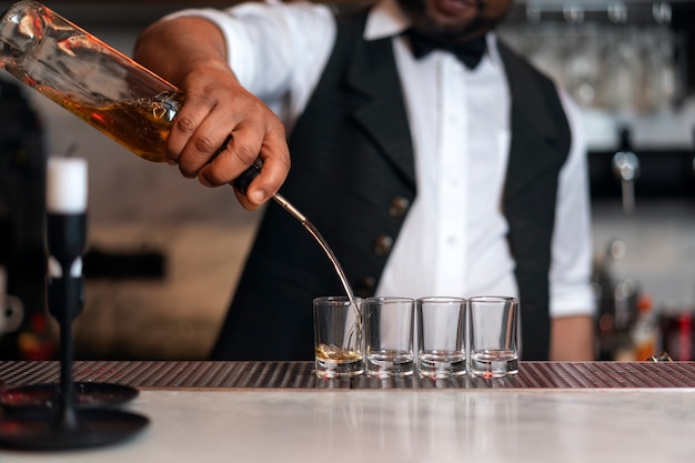 Free photo bartender preparing drink at bar