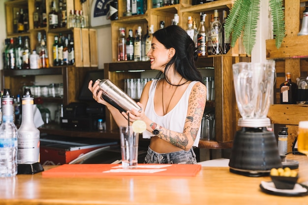 Free photo bartender shaking cocktail