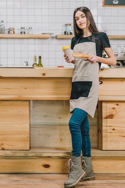 Bartender with drink and pastry