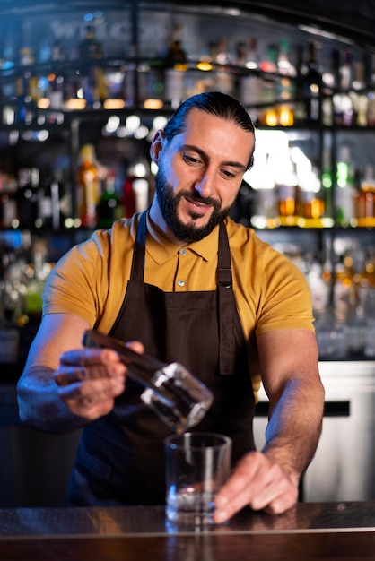 Free photo bartender working in a club