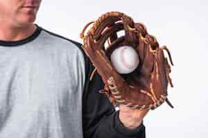 Free photo baseball hand held in glove