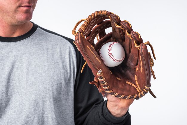 Baseball hand held in glove