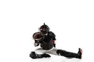 Free photo baseball player, pitcher in a black uniform practicing and training isolated on a white background.