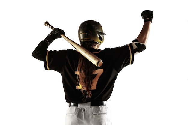 Free photo baseball player, pitcher in a black uniform practicing and training isolated on a white background.