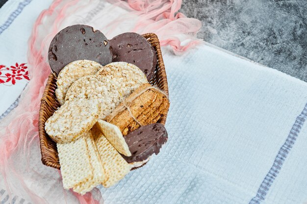 A basket of biscuits with a tablecloth.