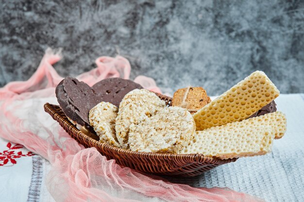 A basket of biscuits with a tablecloth.