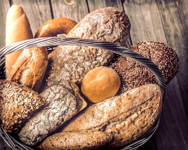 a basket of a variety of fresh bread close up