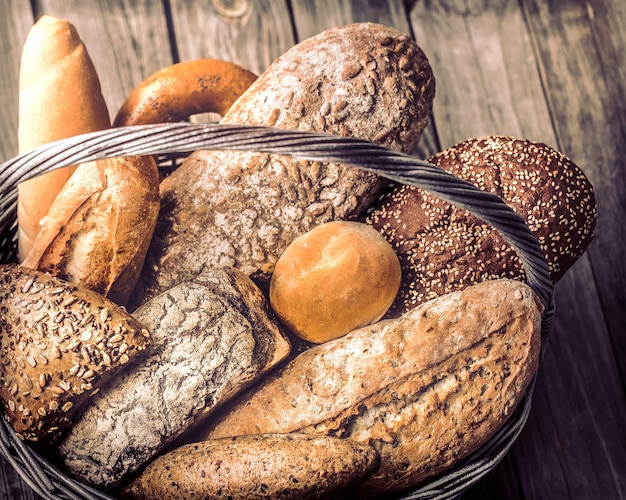 a basket of a variety of fresh bread close up